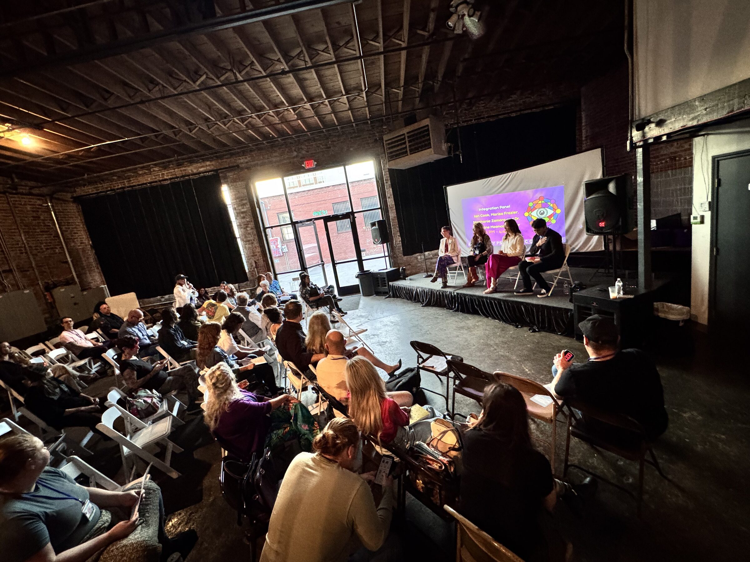 Panel discussion with speakers on stage at the 2025 Kansas City Psychedelic Conference